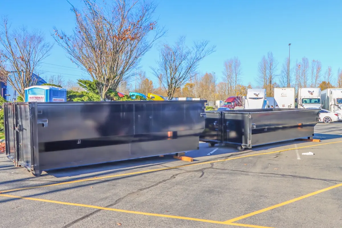 Professional dumpster rental service with roll-off container on residential driveway in Marlin